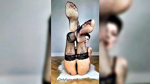 Brunette in fishnet stockings showing soles and legs in foot fetish POV