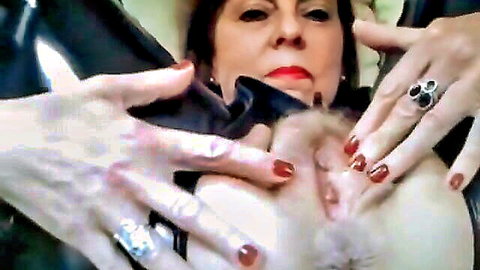 Brunette MILF in shiny latex PVC with hands grabbing her face closeup