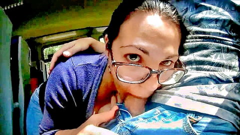 Brunette with glasses kissing boyfriend in vehicle, amateur style
