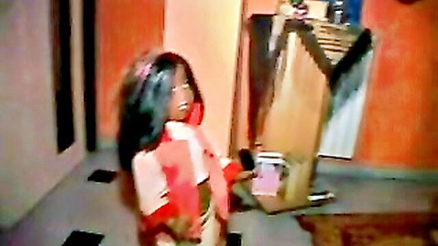 Ebony woman in pink top and red skirt posing teasingly