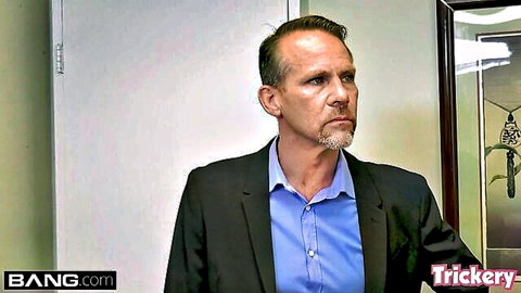 Mature Caucasian therapist husband in suit looking intensely sideways in office