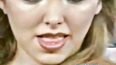 Blonde beauty sticks out her wet pink tongue seductively in close-up tease