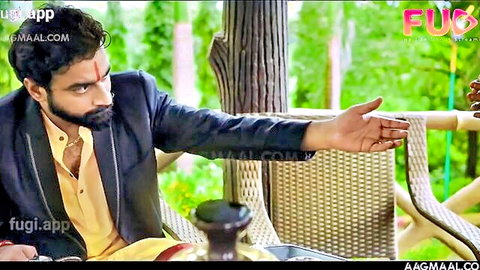 Handsome Indian man in yellow shirt and blazer gesturing seductively
