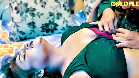Indian babe's big tits groped hard by man's hand in green saree on bed