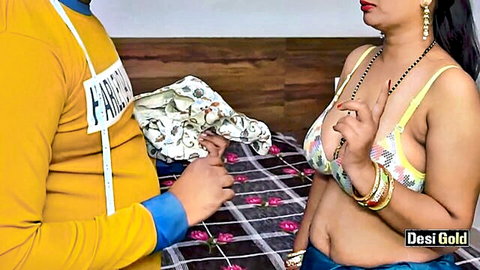 Sexy Desi Indian wife in yellow bra showing deep cleavage and big tits to seducing man on bed