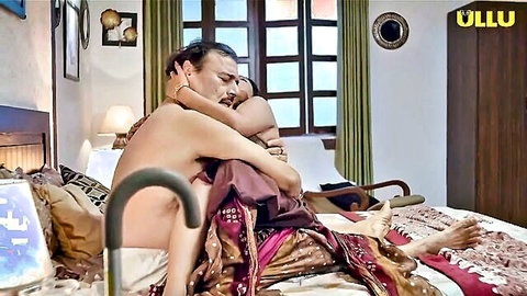 Indian babe in red sari passionately embraced by shirtless hunk on bed