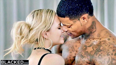 Blonde babe passionately kissing tattooed muscular black stud in steamy interracial scene