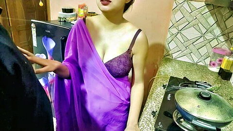 Sexy Indian woman in slipping purple saree exposes lacy bra cleavage as man gropes her waist in kitchen