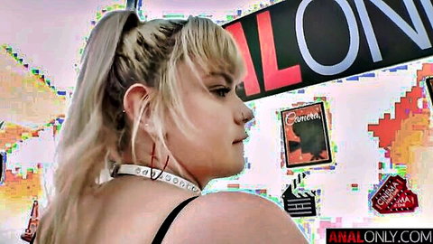 Chubby blonde with big natural tits posing sideways in black top at analonly studio