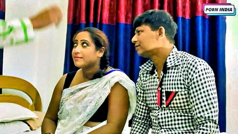 Surprised busty Indian MILF in white saree stares as man's hand reaches for her cleavage