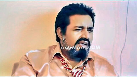 Bearded Indian man in silk shirt and tie, intense gaze from Sauteli MILF episode