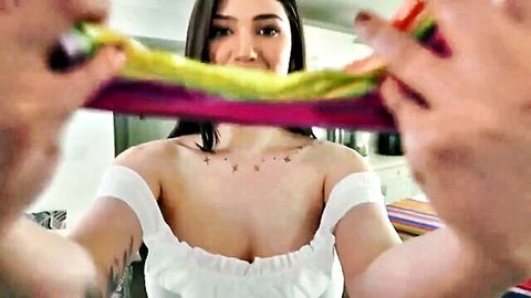 Alyx Star playfully gagged with colorful scarves in low-cut white off-shoulder top, teasing cleavage