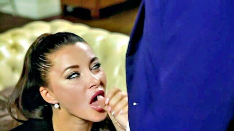 Brunette MILF with pouty lips sticks tongue out licking cock bulge in blue pants POV