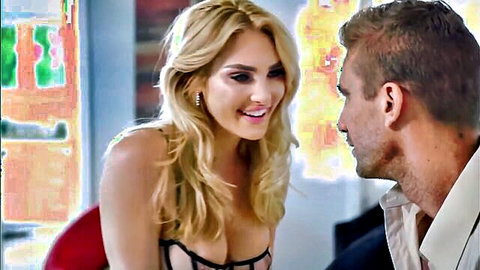 Blonde bombshell in black lace lingerie with huge tits smiles seductively at handsome man