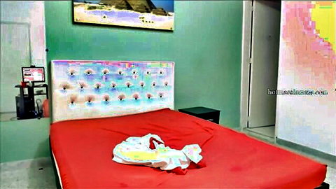 Youthful Indian couple bedroom scene with red bed setup
