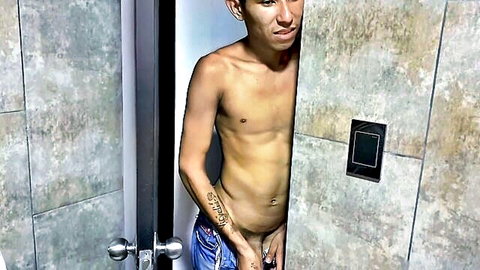 Tattooed Asian man exposes hard cock through jeans in teasing peek