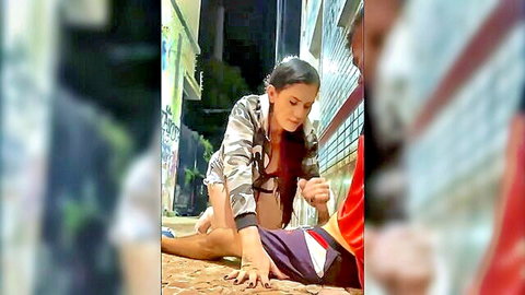 Curvy Latina brunette in open jacket kneels over soccer guy in graffiti alley pulling his shorts for public seduction