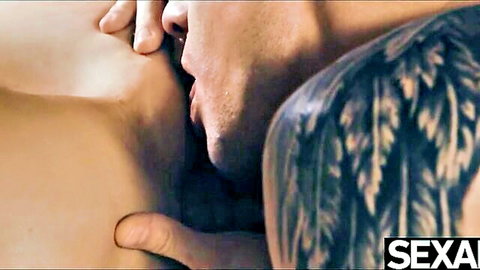 Tattooed man passionately sucking on stunning girl's big natural tits during ride