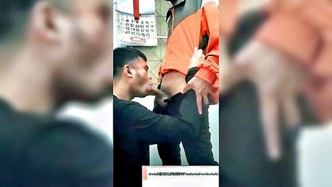 Kneeling Asian man rims the exposed ass of Thai inmate in orange uniform during intense gay encounter.