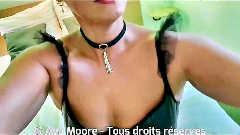 Busty brunette in sheer black top and choker necklace teasing deep cleavage selfie