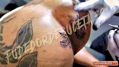 Marcio Baiano getting tattoo on muscular ass by female artist