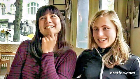 Amateur lesbian couple: smiling Asian brunette and blonde in casual clothes