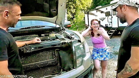 Amy Quinn in pink top and blue skirt surprised by two dominant men outdoors