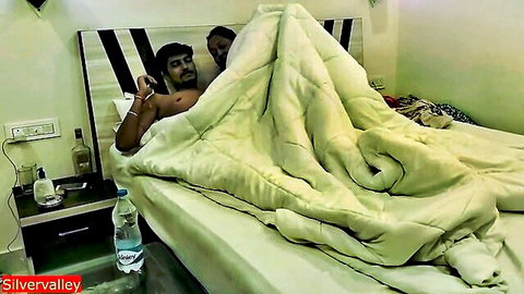 Indian Bengali couple in intimate honeymoon bed scene