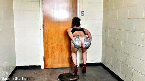 Curvy brunette MILF big ass exposed in silver tape bondage bent over door nude solo