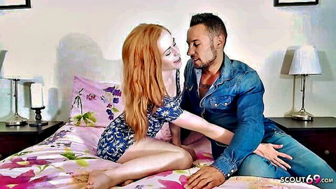 Redhead babe in short floral dress seduces muscular guy on bed