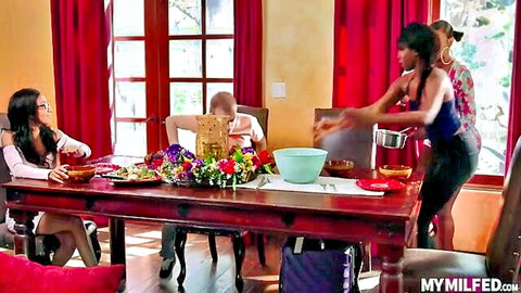 Ebony Mystique at roundtable with curvy MILFs and young stud in steamy setup