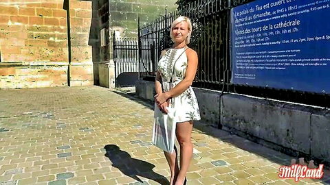 Blonde MILF Kim in sexy floral mini dress teasing outdoors