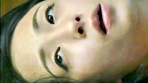 Seductive Asian woman with dark hair and parted lips in close-up
