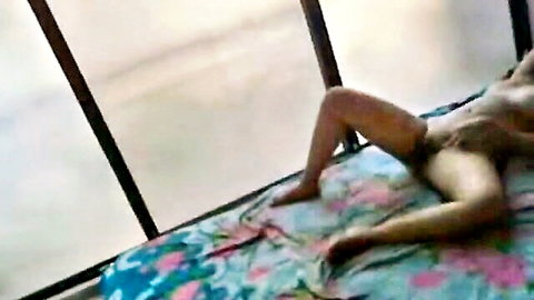 Dark South Asian babe lies nude on bed spreading legs fingering wet pussy solo