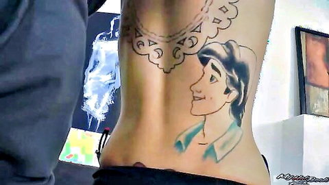 Brunette babe's bare back tattooed with sexy Prince Eric from Little Mermaid