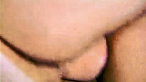 Close-up of pink juicy pussy lips exposed with thin thong string pulled aside