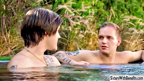 Tattooed petite teen and stepbrother facing intimately in outdoor pool