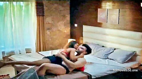 Indian brunette babe in red lingerie straddles muscular hunk's lap in passionate bedroom embrace