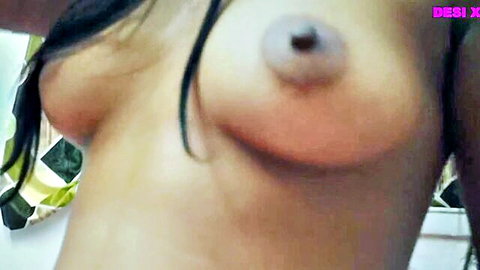 Close-up of Desi Indian woman's bare saggy tits with dark erect nipples