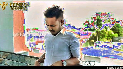 Handsome South Asian man in light blue shirt standing thoughtfully on balcony