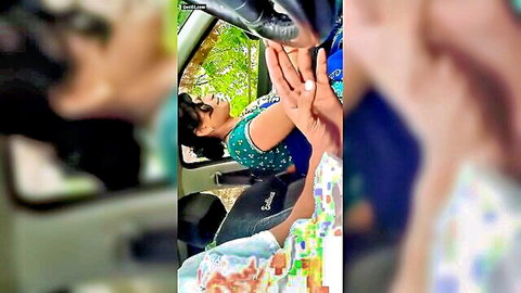 Smiling Desi aunty in blue saree leaning from car window