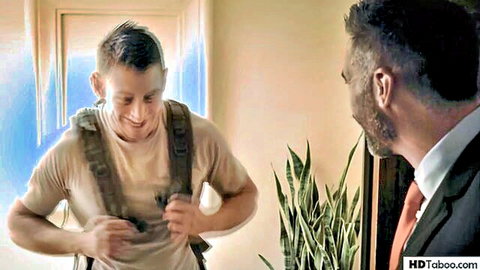 Young soldier smiling while holding crotch area teasing older suited man in taboo encounter