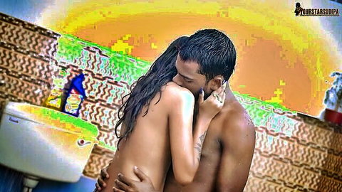 Petite nude Indian babe with small tits passionately neck-kissed by muscular tattooed stud in steamy bathroom.
