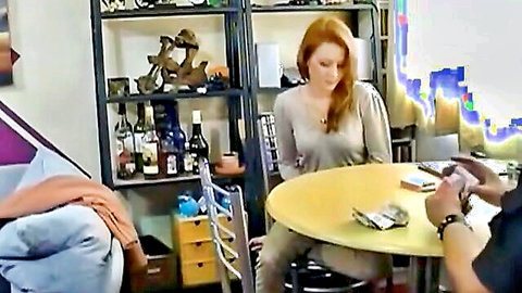 Redhead woman losing at strip poker table with cards and cash