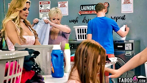Young guy surrounded by busty MILFs in laundromat tease