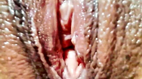 Close-up of shaved wet pussy with spread labia