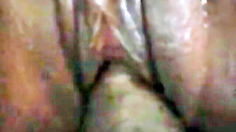 Blurry extreme closeup of wet pink pussy folds and labia spread wide open