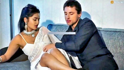 Sexy Indian beauty in white saree spreads legs on couch as suited man gropes her thigh