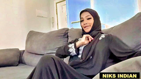 Burqa-clad Indian beauty smiling seductively in teasing pose