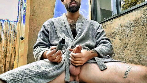 Bearded hairy man in open bathrobe using Fleshlight on thick cock